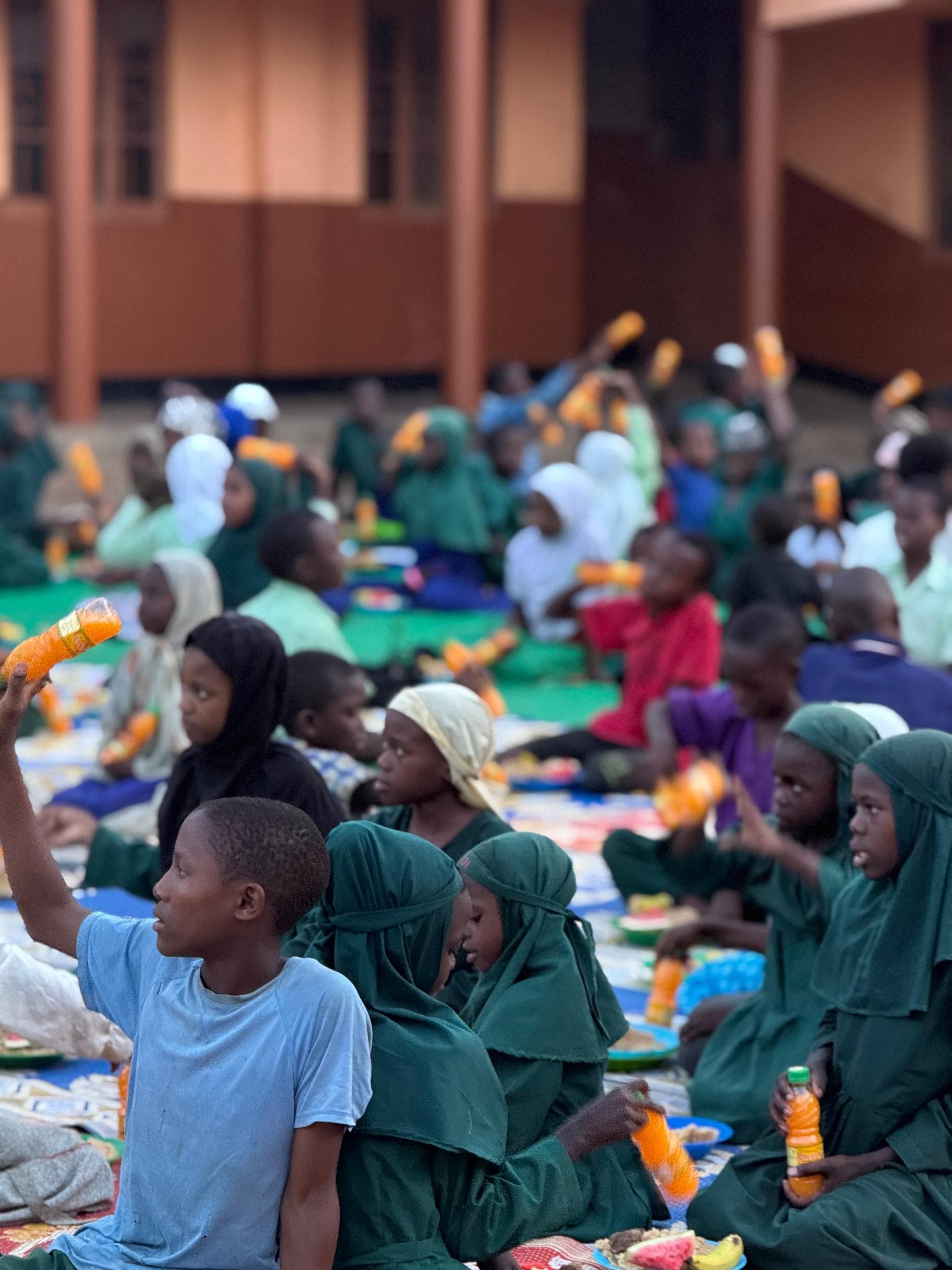 Children sharing a hot meal at a Musana community feeding event
